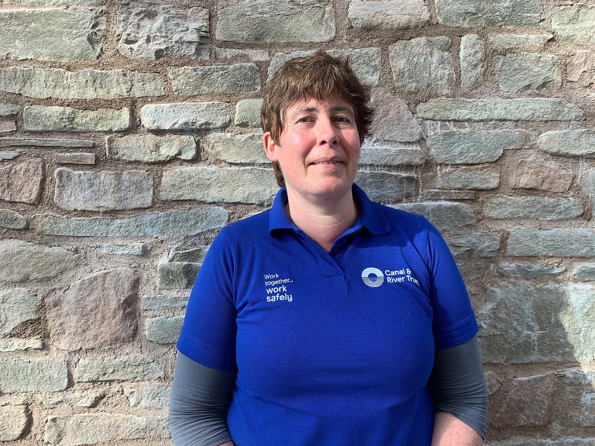 A portrait of Clare Parsons who is wearing a blue River and Canal Trust T-shirt