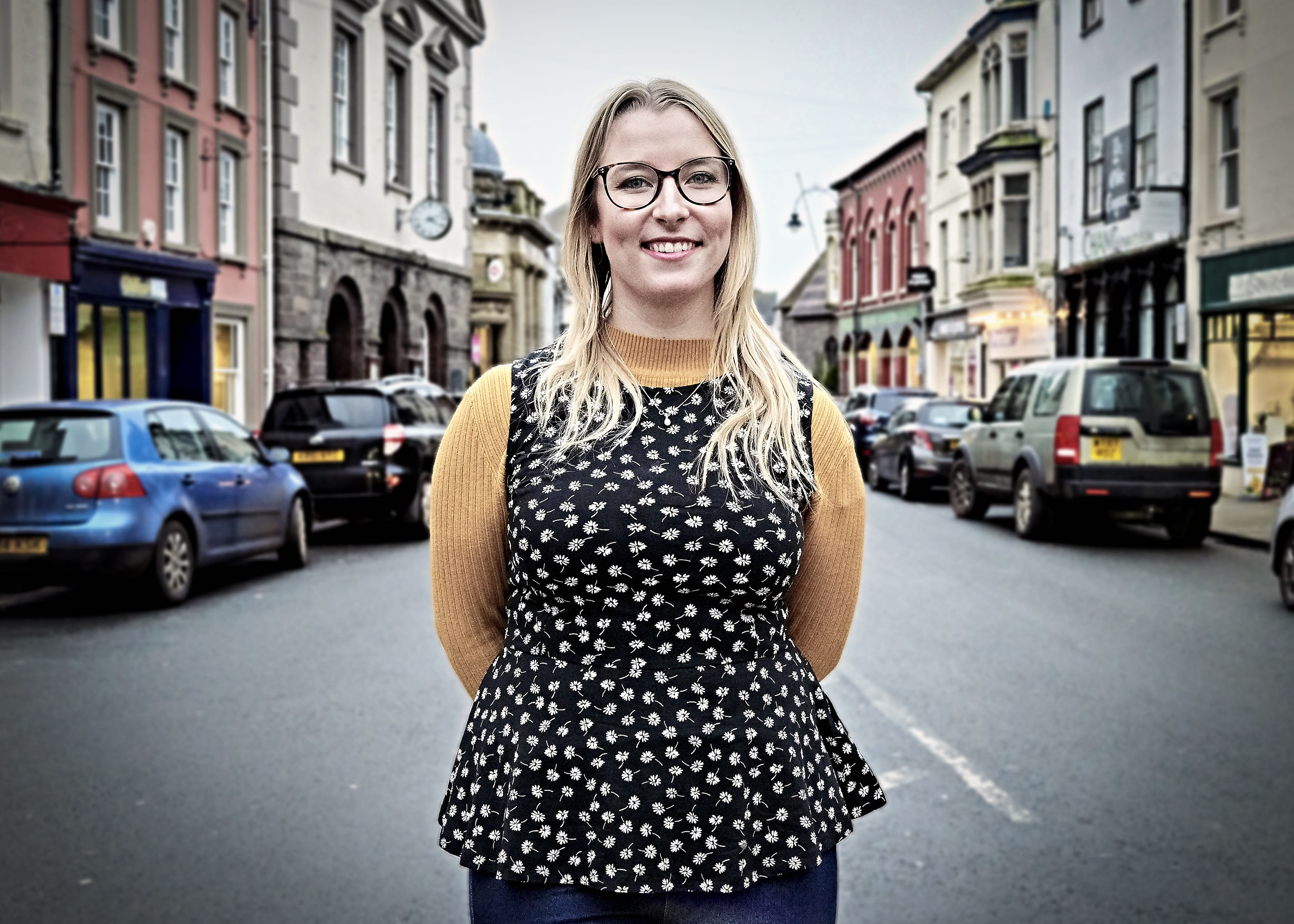 Portrait of Gemma Schiebe, who has long blonde, hair, wearing glasses