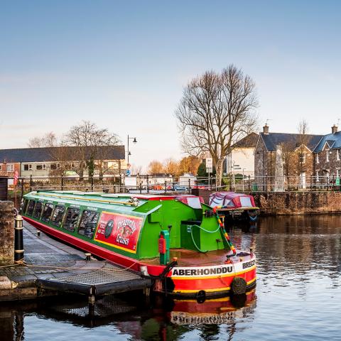 Brecon canal with colourful canal boats in the foreground